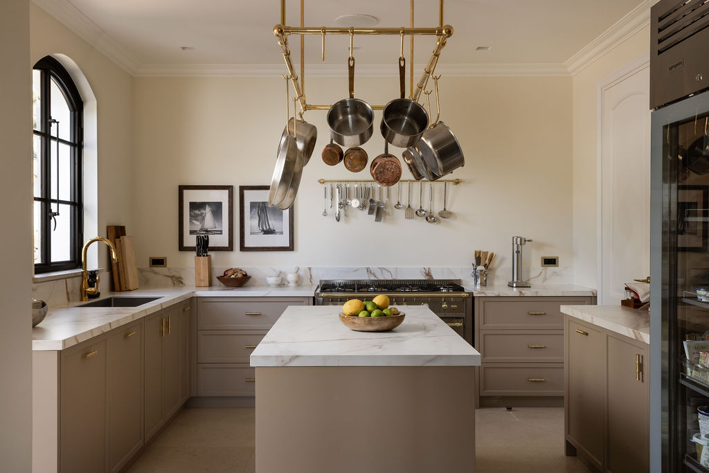Olive D’Or — Kitchen with brass pot rack